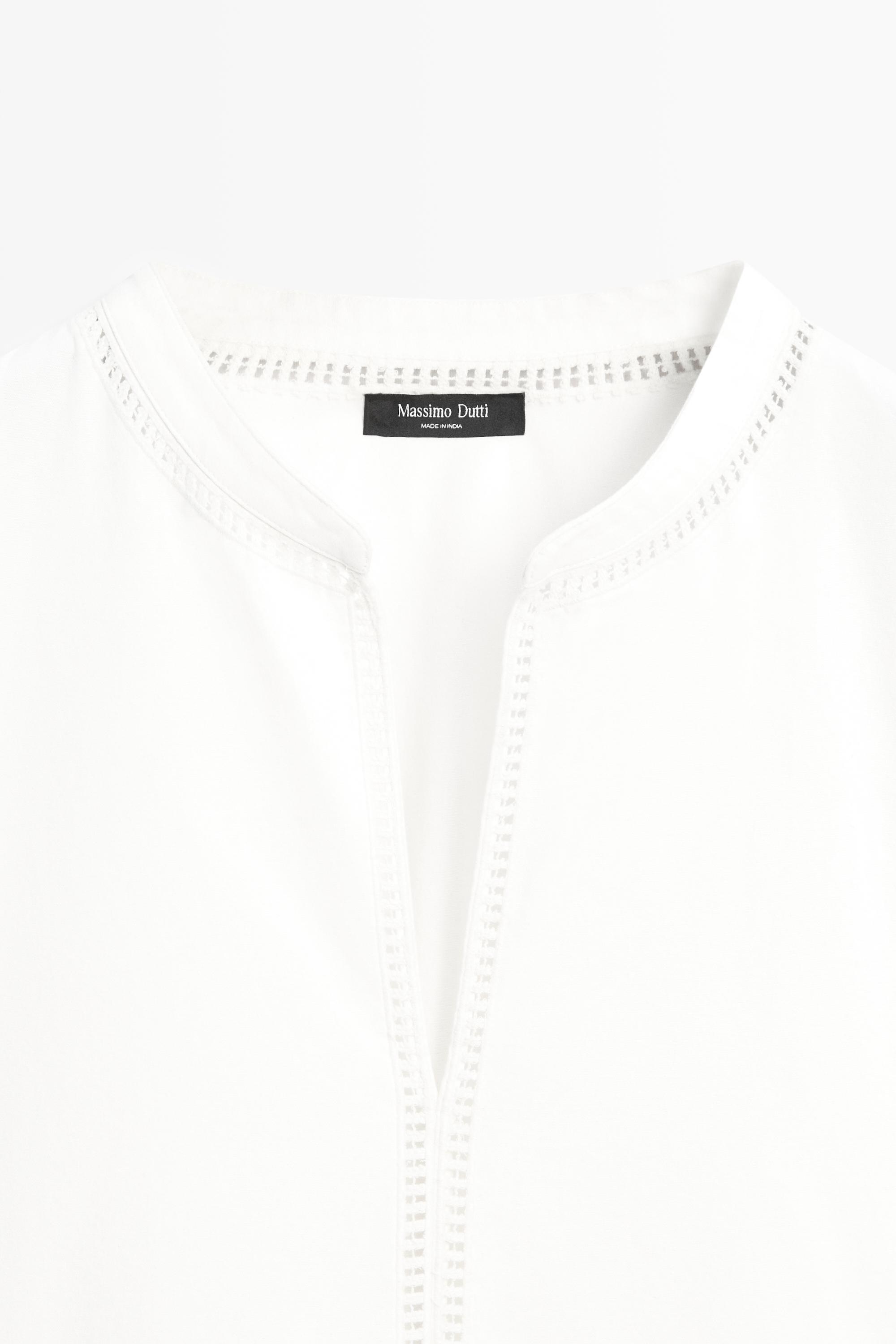 Embroidered blouse with fringed hem
